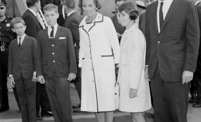 FILE - Attorney General Robert F. Kennedy, right, wife Ethel Kennedy, and children, from left, Bobby, Joseph, and Kathleen, second right, pose at Kennedy International Airport in New York, July 1, 1964, shortly after they returned from a one-week trip to West Germany and Poland. (AP Photo/Matty Zimmerman, File)