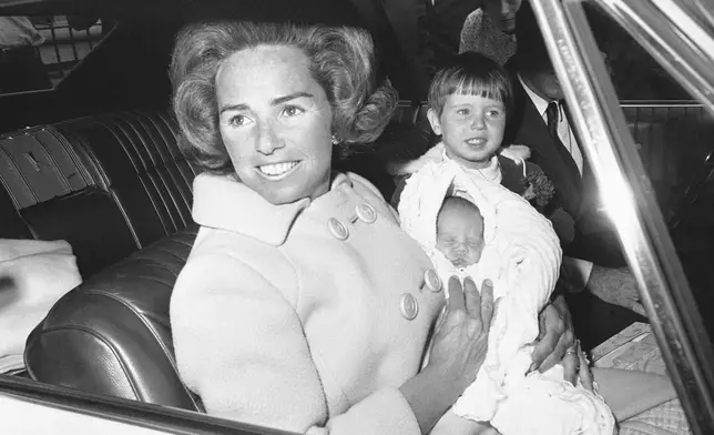 FILE - Ethel Kennedy holds her new son, Douglas Harriman Kennedy, with two-year-old Christopher Kennedy, right, as they leave Georgetown University in Washington, April 13, 1967, for home. (AP Photo/Henry Burroughs, File)