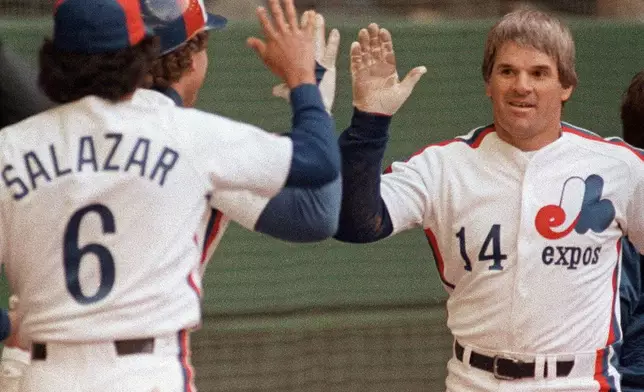 FILE - Montreal Expos Pete Rose celebrates his 4,000th career hit with teammates against the Philadelphia Phillies at Olympic Stadium in Montreal on April 13, 1984. (Ron Poling/The Canadian Press via AP, File)