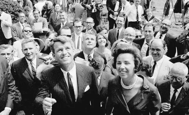 FILE - Atty. Gen. Robert F. Kennedy, front, waves with his wife, Ethel Kennedy, right, shortly after announcing he will seek the Democratic nomination for the U.S. senate from New York at Gracie Mansion, the official residence of New York Mayor Robert Wagner, in New York, Aug. 25, 1964. (AP Photo, File)