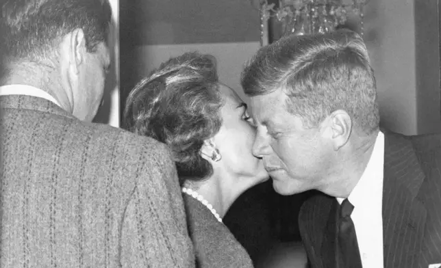 FILE - Mrs. Ethel Kennedy gives a kiss to her brother-in-law, President-elect John Kennedy, at his Georgetown home, Nov. 27, 1960, in Washington. (AP Photo/Henry Griffin, File)