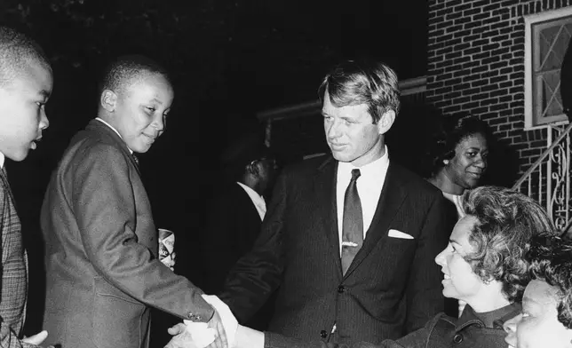 FILE - Ethel Kennedy shakes hands with Martin Luther King III after she and her husband Robert F. Kennedy, center, visited his mother Coretta Scott King, at her Atlanta home, April 8, 1968. Another of the slain civil rights leader Martin Luther King Jr's sons, Dexter, is at left. (AP Photo, File)