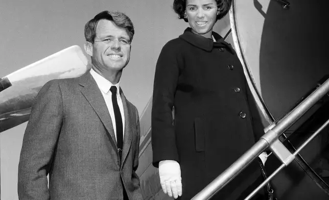 FILE - U.S. Senator-elect Robert F. Kennedy is shown with his wife Ethel boarding plane, Nov. 4, 1964, in New York City at LaGuardia Airport for flight to Glens Falls, N.Y. (AP Photo/File)