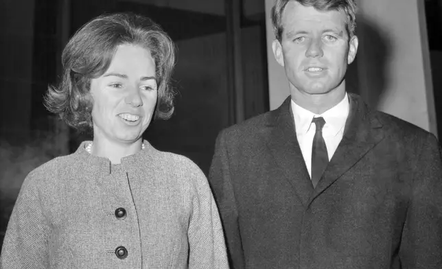 FILE - Robert F. Kennedy, 38-year-old American attorney general and brother of the late U.S. President, John F. Kennedy, is accompanied by his wife Ethel, leaving the U.S. Embassy for the airport in London, Jan. 25, 1964, to fly to Derbyshire to visit the grave of his sister who died in 1947 in a plane crash. (AP Photo/Laurence Harris, File)