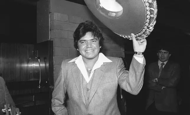 FILE - Los Angeles Dodger pitcher Fernando Valenzuela tips his sombrero at a news conference after he was named National League Rookie of the Year, Dec. 2, 1981, in Los Angeles. Fernando Valenzuela, the Mexican-born phenom for the Los Angeles Dodgers who inspired “Fernandomania” while winning the NL Cy Young Award and Rookie of the Year in 1981, has died Tuesday, Oct. 22, 2024.(AP Photo/Wally Fong, File)