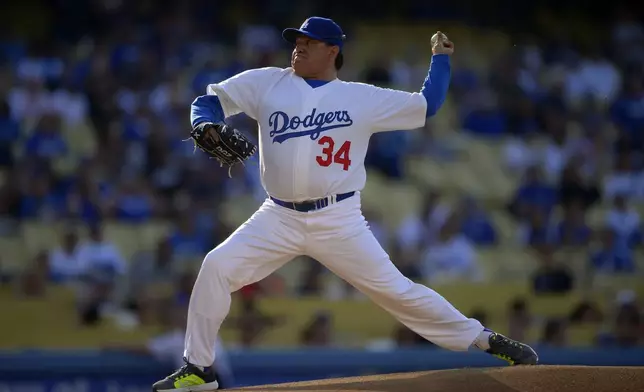 FILE - Fernando Valenzuela throws to the plate during the Old-Timers baseball game, June 8, 2013, in Los Angeles. Fernando Valenzuela, the Mexican-born phenom for the Los Angeles Dodgers who inspired “Fernandomania” while winning the NL Cy Young Award and Rookie of the Year in 1981, has died Tuesday, Oct. 22, 2024. (AP Photo/Mark J. Terrill, File)