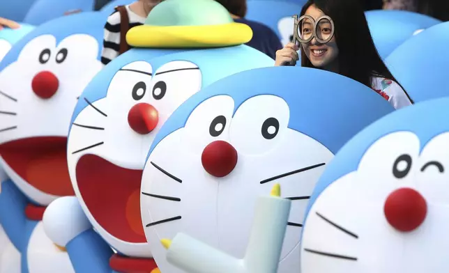 FILE - Models of Doraemon, one of Japan's most popular manga and anime characters, are displayed in Shanghai on April 28, 2013. (AP Photo/File)