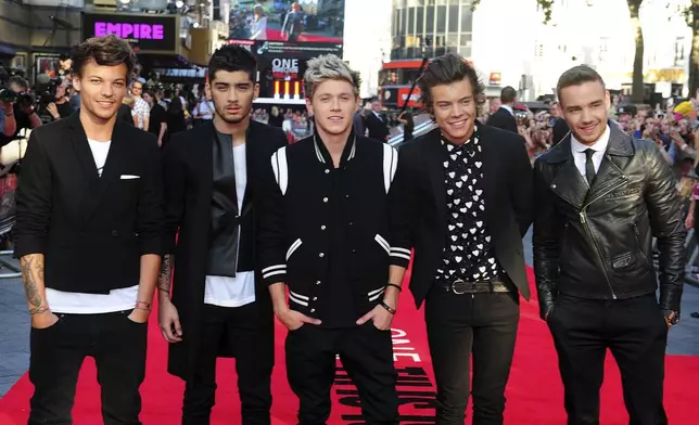 FILE - Louis Tomlinson, from left, Zayn Malik, Niall Horan, Harry Styles and Liam Payne arrive for the World Premiere of "One Direction: This Is Us," at the Empire Leicester Square, in London, Aug. 20, 2013. (Ian West/PA via AP, File)