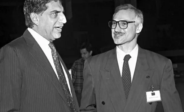 FILE - Leading Indian industrialists Jamshed J. Godrej, right, and Ratan Tata, left, chat during a business meeting in Calcutta, Jan. 4, 1995. (AP Photo, File)