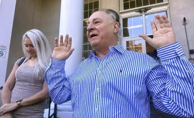 Richard Schiffer Jr., who faces witness intimidation and other charges related to the Karen Read case, greets supporters on the steps outside Stoughton District Court following his arraignment, Wednesday, Oct. 23, 2024 in Stoughton, Mass. (AP Photo/Michael Casey)