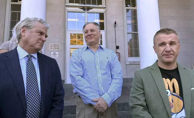 Richard Schiffer Jr., center, who faces witness intimidation and other charges related to the Karen Read case, greets supporters outside Stoughton District Court following his arraignment, Wednesday, Oct. 23, 2024 in Stoughton, Mass. (AP Photo/Michael Casey)