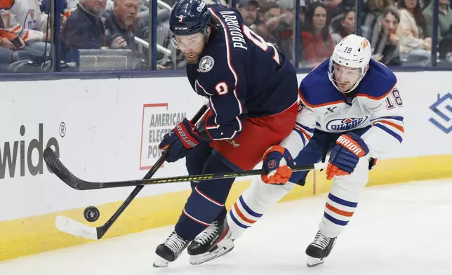 Edmonton Oilers' Zach Hyman, right, chases Columbus Blue Jackets' Ivan Provorov behind the net during the first period of an NHL hockey game Monday, Oct. 28, 2024, in Columbus, Ohio. (AP Photo/Jay LaPrete)