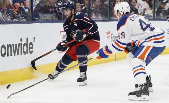 Columbus Blue Jackets' Justin Danforth, left, and Edmonton Oilers' Ty Emberson chase the puck during the second period of an NHL hockey game Monday, Oct. 28, 2024, in Columbus, Ohio. (AP Photo/Jay LaPrete)