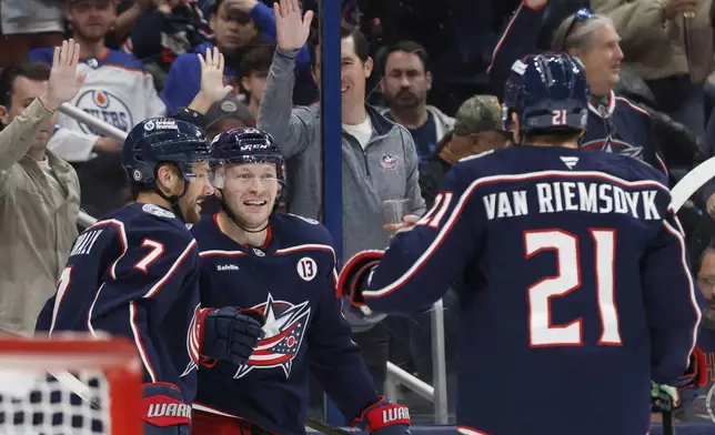 Columbus Blue Jackets' Mathieu Olivier, center, celebrates his goal against the Edmonton Oilers with teammates Sean Kuraly, left, and James van Riemsdyk during the second period of an NHL hockey game Monday, Oct. 28, 2024, in Columbus, Ohio. (AP Photo/Jay LaPrete)