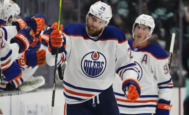 Edmonton Oilers center Leon Draisaitl celebrates his goal against the Seattle Kraken during the second period of a preseason NHL hockey game Wednesday, Oct. 2, 2024, in Seattle. (AP Photo/Lindsey Wasson)