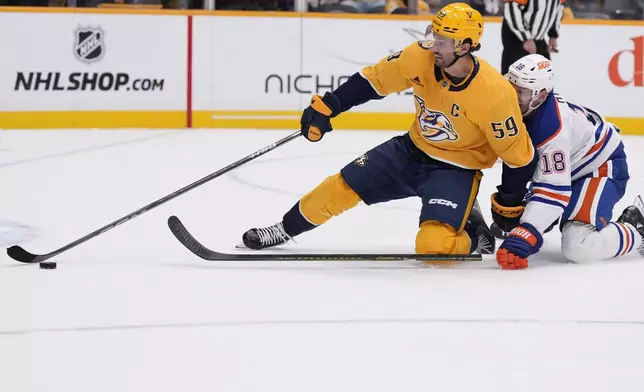 Nashville Predators defenseman Roman Josi (59) chases the past Edmonton Oilers left wing Zach Hyman (18) during the third period of an NHL hockey game Thursday, Oct. 17, 2024, in Nashville, Tenn. (AP Photo/George Walker IV)