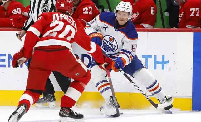 Edmonton Oilers center Jeff Skinner (53) passes the puck against Detroit Red Wings defenseman Albert Johansson (20) during the first period of an NHL hockey game Sunday, Oct. 27, 2024, in Detroit. (AP Photo/Duane Burleson)