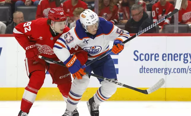 Detroit Red Wings center Marco Kasper (92) tangles with Edmonton Oilers center Jeff Skinner (53) during the first period of an NHL hockey game Sunday, Oct. 27, 2024, in Detroit. (AP Photo/Duane Burleson)