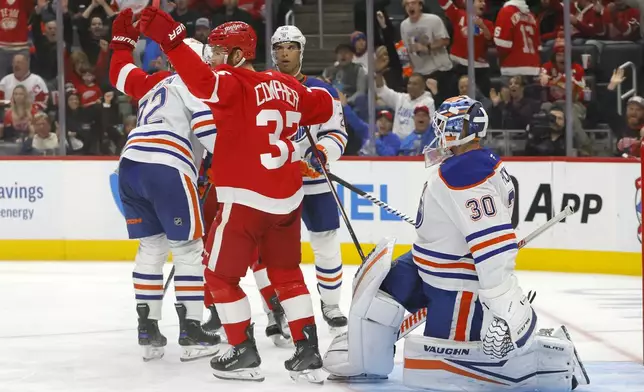 Detroit Red Wings left wing J.T. Compher (37) celebrates in front of Edmonton Oilers goaltender Calvin Pickard (30) after a goal was scored by teammate Andrew Copp during the second period of an NHL hockey game Sunday, Oct. 27, 2024, in Detroit. (AP Photo/Duane Burleson)