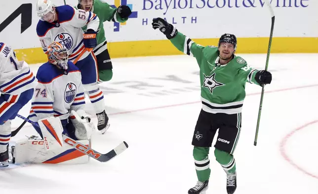 Dallas Stars centers Logan Stankoven (11) and Roope Hintz (24) celebrate after a goal against Edmonton Oilers goaltender Stuart Skinner (74) in the third period during an NHL hockey game on Saturday, Oct. 19, 2024, in Dallas. (AP Photo/Richard W. Rodriguez)