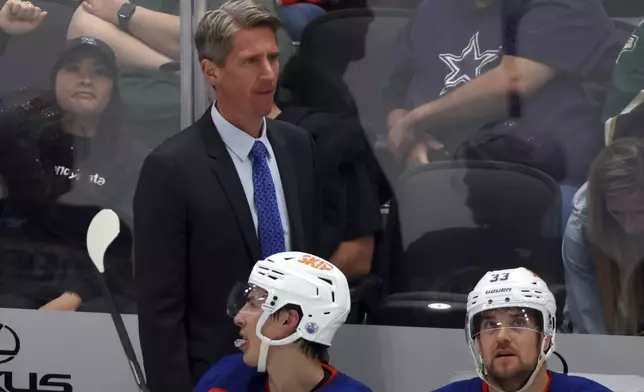 Edmonton Oilers head coach Kris Knoblauch stands behind the team bench in the third period during an NHL hockey game against the Dallas Stars, Saturday, Oct. 19, 2024, in Dallas. (AP Photo/Richard W. Rodriguez)