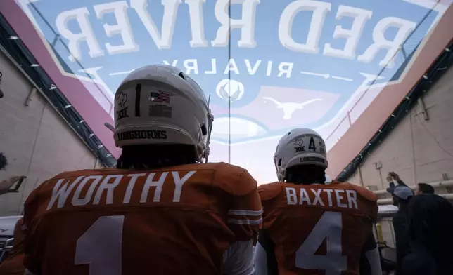 FILE - Texas wide receiver Xavier Worthy (1) and running back CJ Baxter (4) wait in the tunnel before an NCAA college football game against Oklahoma at the Cotton Bowl, Saturday, Oct. 7, 2023, in Dallas. (AP Photo/Jeffrey McWhorter, File)