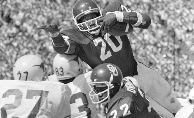 FILE - Oklahoma's Billy Sims (20) goes airborne in an effort to score from the two -yard line in the first quarter of an NCAA college football game against Texas, Saturday Oct.7, 1978, in Dallas. (AP Photo/File)