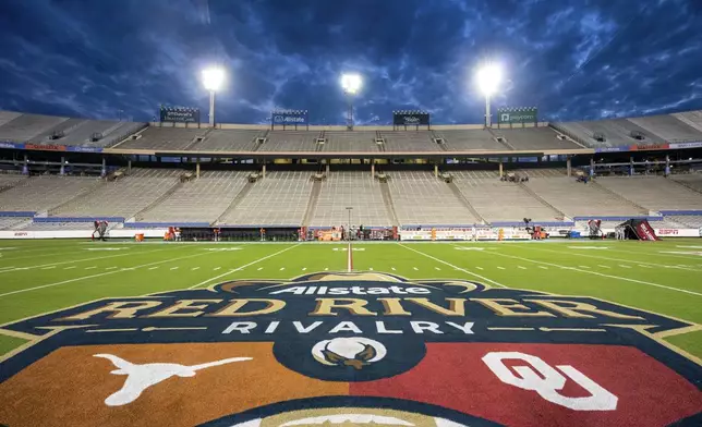 FILE - The logos of Texas and Oklahoma are painted at midfield before an NCAA college football game at the Cotton Bowl, Saturday, Oct. 7, 2023, in Dallas. (AP Photo/Jeffrey McWhorter, File)