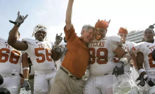 FILE - In this Oct. 11, 2008, file photo, Texas coach Mack Brown celebrates with Texas defensive tackle Roy Miller (99) and others after beating No. 1 Oklahoma 45-35 in an NCAA college football game in Dallas.AP Photo/Tony Gutierrez, File)