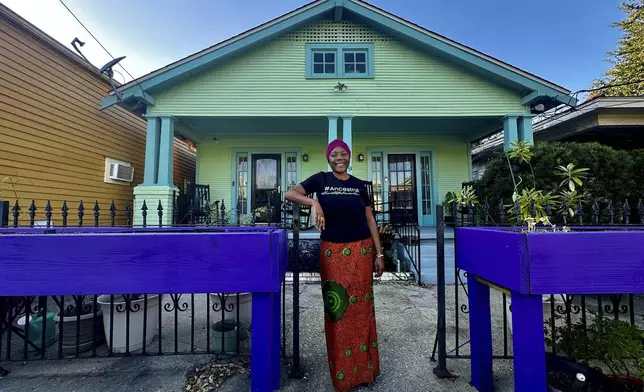 Candice Henderson-Chandler poses in front of her home, also known as the Freedom House, where Civil Rights leaders in New Orleans once used as a safe house, Oct. 23 2024. (AP Photo/Stephen Smith)