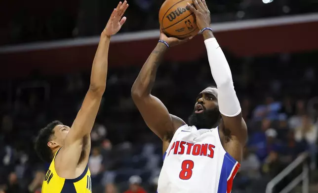 Detroit Pistons forward Tim Hardaway Jr. (8) takes a shot against Indiana Pacers guard Tyrese Haliburton during the first half of an NBA basketball game Wednesday, Oct. 23, 2024, in Detroit. (AP Photo/Duane Burleson)