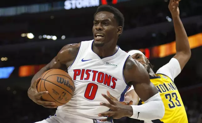 Detroit Pistons center Jalen Duren (0) grabs a rebound against Indiana Pacers center Myles Turner (33) during the first half of an NBA basketball game Wednesday, Oct. 23, 2024, in Detroit. (AP Photo/Duane Burleson)