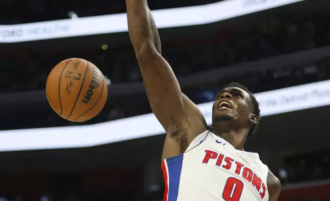 Detroit Pistons center Jalen Duren (0) dunks the ball against the Indiana Pacers during the first half of an NBA basketball game Wednesday, Oct. 23, 2024, in Detroit. (AP Photo/Duane Burleson)