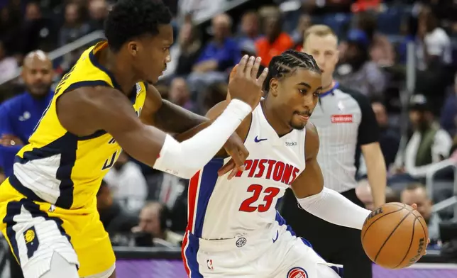 Detroit Pistons guard Jaden Ivey (23) drives against Indiana Pacers guard Bennedict Mathurin during the first half of an NBA basketball game Wednesday, Oct. 23, 2024, in Detroit. (AP Photo/Duane Burleson)