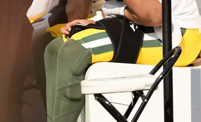 Green Bay Packers' Jordan Love looks down as he sits on the bench during the second half of an NFL football game against the Jacksonville Jaguars Sunday, Oct. 27, 2024, in Jacksonville, Fla. (AP Photo/John Bazemore)