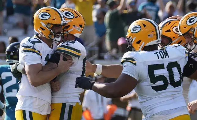 Green Bay Packers' Brandon McManus (17) is congratulated after kicking the game-winning field goal during the second half of an NFL football game against the Jacksonville Jaguars Sunday, Oct. 27, 2024, in Jacksonville, Fla. (AP Photo/John Bazemore)