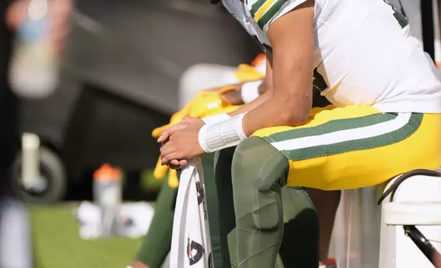 Green Bay Packers' Jordan Love sits on the bench during the second half of an NFL football game against the Jacksonville Jaguars Sunday, Oct. 27, 2024, in Jacksonville, Fla. (AP Photo/John Bazemore)