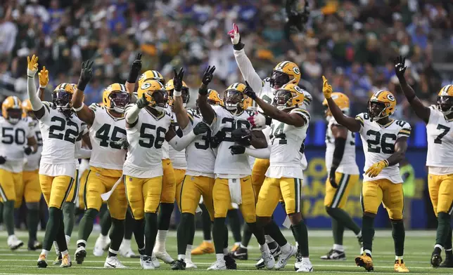 Green Bay Packers players celebrate an interception by safety Xavier McKinney (29) during the second half of an NFL football game against the Los Angeles Rams Sunday, Oct. 6, 2024, in Inglewood, Calif. (AP Photo/Ryan Sun)