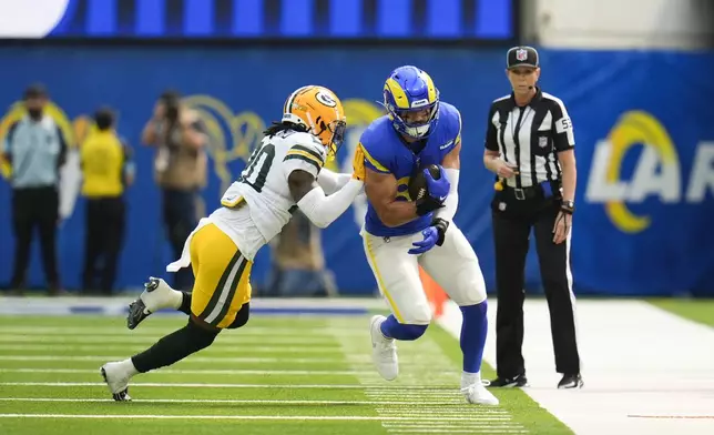 Los Angeles Rams tight end Colby Parkinson, right, is pushed out of bounce by Green Bay Packers safety Javon Bullard during the first half of an NFL football game Sunday, Oct. 6, 2024, in Inglewood, Calif. (AP Photo/Gregory Bull)