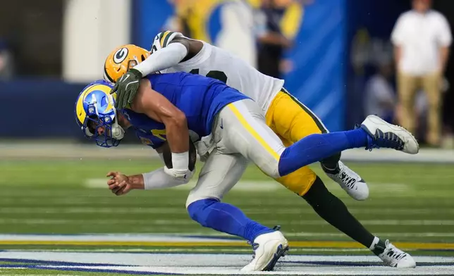 Green Bay Packers linebacker Edgerrin Cooper (56) sacks Los Angeles Rams quarterback Matthew Stafford (9) during the first half of an NFL football game Sunday, Oct. 6, 2024, in Inglewood, Calif. (AP Photo/Gregory Bull)