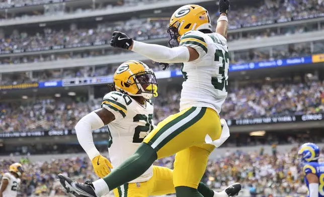 Green Bay Packers cornerback Evan Williams (33) celebrates with safety Javon Bullard (20) after forcing an incompletion against the Los Angeles Rams during the first half of an NFL football game Sunday, Oct. 6, 2024, in Inglewood, Calif. (AP Photo/Ryan Sun)