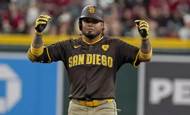 San Diego Padres' Luis Arraez celebrates after his double against the Arizona Diamondbacks during the sixth inning of a baseball game, Sunday, Sept. 29, 2024, in Phoenix. (AP Photo/Darryl Webb)