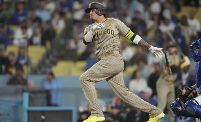 San Diego Padres' Manny Machado watches his single during the first inning of a baseball game against the Los Angeles Dodgers, Thursday, Sept. 26, 2024, in Los Angeles. (AP Photo/Ashley Landis)