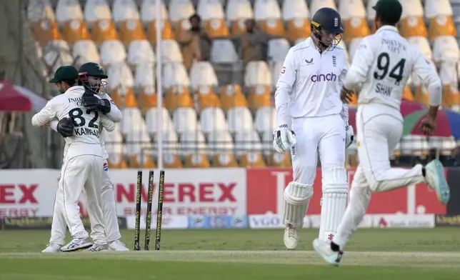 Pakistan's Mohammad Rizwan, second left, celebrates with teammate after stump out to England's Zak Crawley, second right, during the third day of the second test cricket match between Pakistan and England, in Multan, Pakistan, Thursday, Oct. 17, 2024. (AP Photo/K.M. Chaudary)