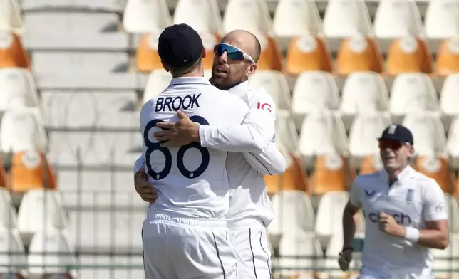 England's Jack Leach, center, celebrates with teammate after taking the wicket of Pakistan's Abdullah Shafique during the first day of the second test cricket match between Pakistan and England, in Multan, Pakistan, Tuesday, Oct. 15, 2024. (AP Photo/K.M. Chaudary)