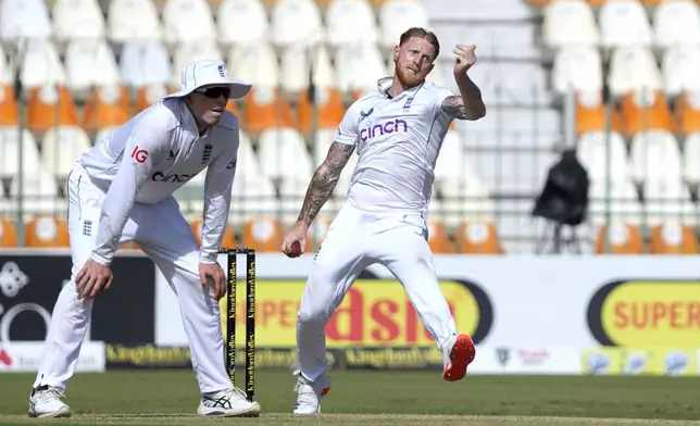 England's Ben Stokes, right, bowls as Zak Crawley fields during the first day of the second test cricket match between Pakistan and England, in Multan, Pakistan, Tuesday, Oct. 15, 2024. (AP Photo/K.M. Chaudary)