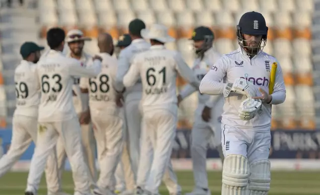 England's Ben Duckett, right, reacts as he walks off the field after his dismissal during the third day of the second test cricket match between Pakistan and England, in Multan, Pakistan, Thursday, Oct. 17, 2024. (AP Photo/K.M. Chaudary)