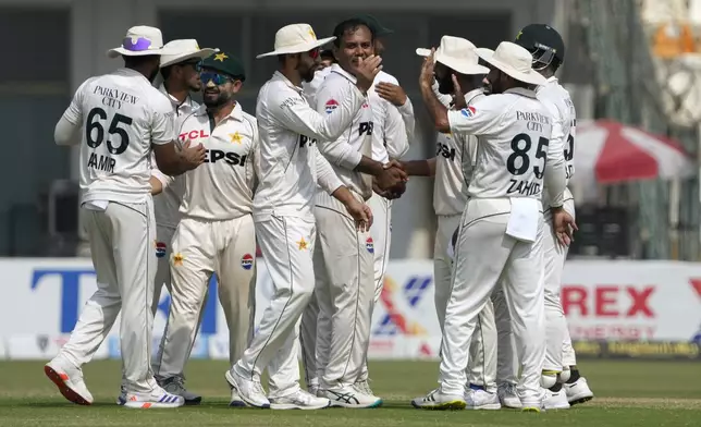 Pakistan's Noman Ali, center, and teammates celebrates after winning the second test cricket match against England, in Multan, Pakistan, Friday, Oct. 18, 2024. (AP Photo/K.M. Chaudary)