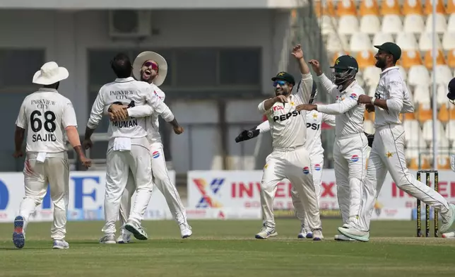 Pakistan's Noman Ali, second left, and teammates celebrates after winning the second test cricket match against England, in Multan, Pakistan, Friday, Oct. 18, 2024. (AP Photo/K.M. Chaudary)