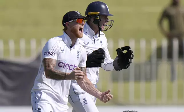 England's Ben Stokes, left, and Jamie Smith, center, celebrates after LWB out Pakistan's Salman Ali Agha during the day two of third test cricket match between Pakistan and England, in Rawalpindi, Pakistan, Friday, Oct. 25, 2024. (AP Photo/Anjum Naveed)